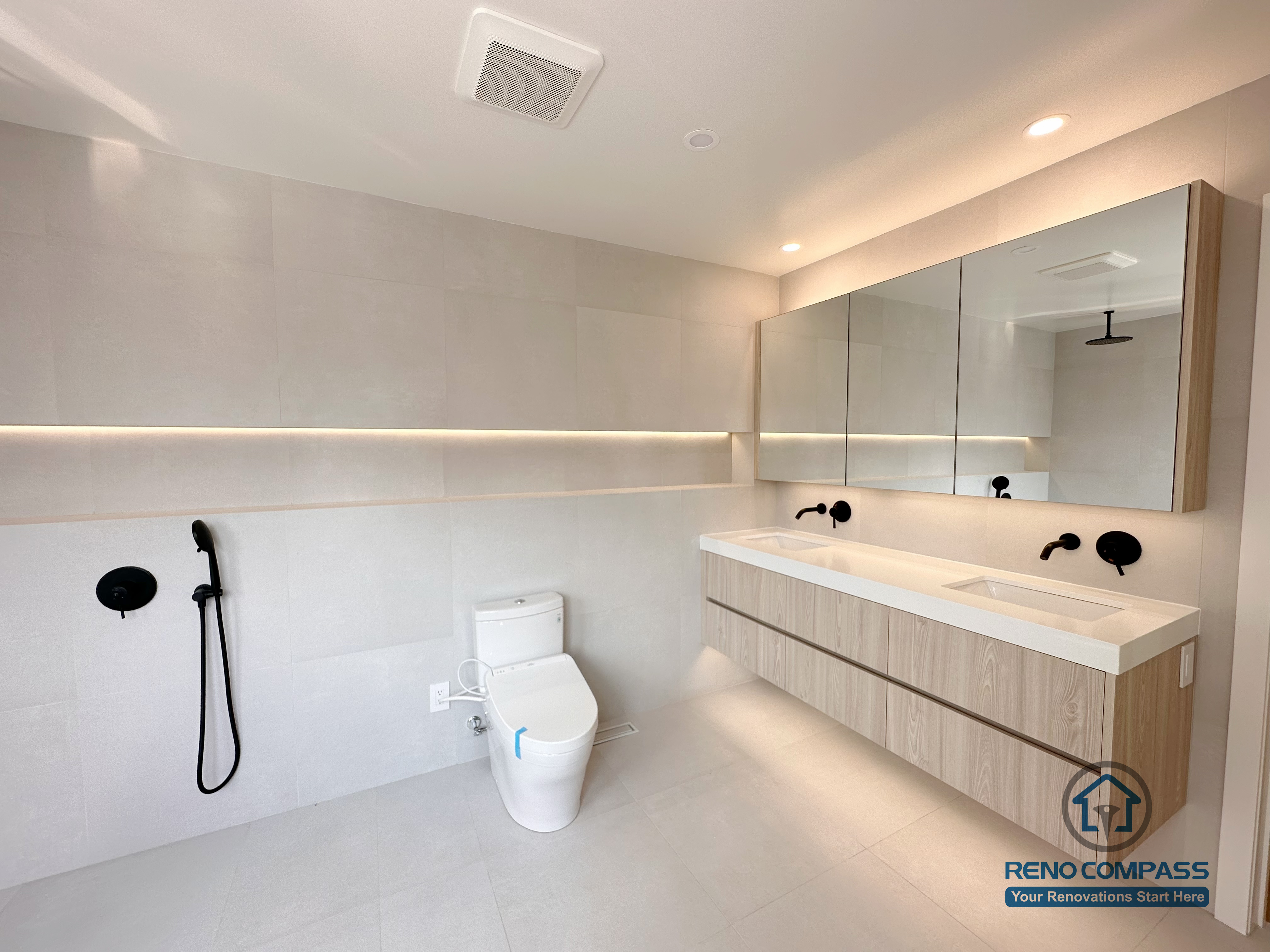 Modern bathroom renovation in Markham featuring a walk-in shower, floating vanity with integrated lighting, wall-mounted fixtures, and a clean neutral color palette. The design emphasizes functionality, easy maintenance, and a calm, spa-inspired atmosphere suitable for everyday use.