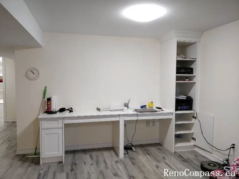 Modern custom-built mudroom featuring white shaker-style storage cabinets, integrated seating bench, open shelving cubbies, and a hanging rod. A perfect organization solution for a Markham home interior upgrade.