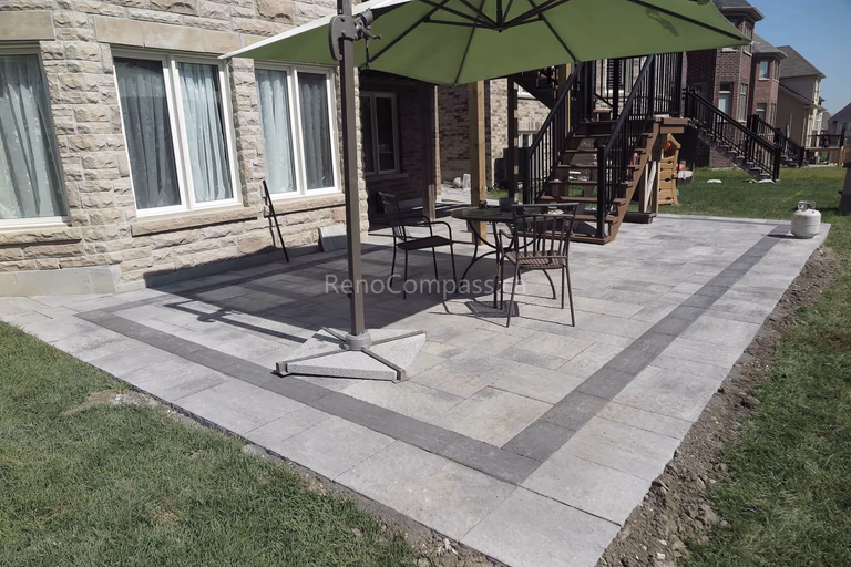 This Markham landscaping project features a professionally installed backyard interlocking patio with clean geometric borders and durable stone pavers. The spacious patio design enhances outdoor living space, creating a functional and elegant area for relaxation and entertainment. Completed by a trusted Toronto renovation company, this backyard upgrade combines modern hardscaping aesthetics with long-term durability and low maintenance performance.