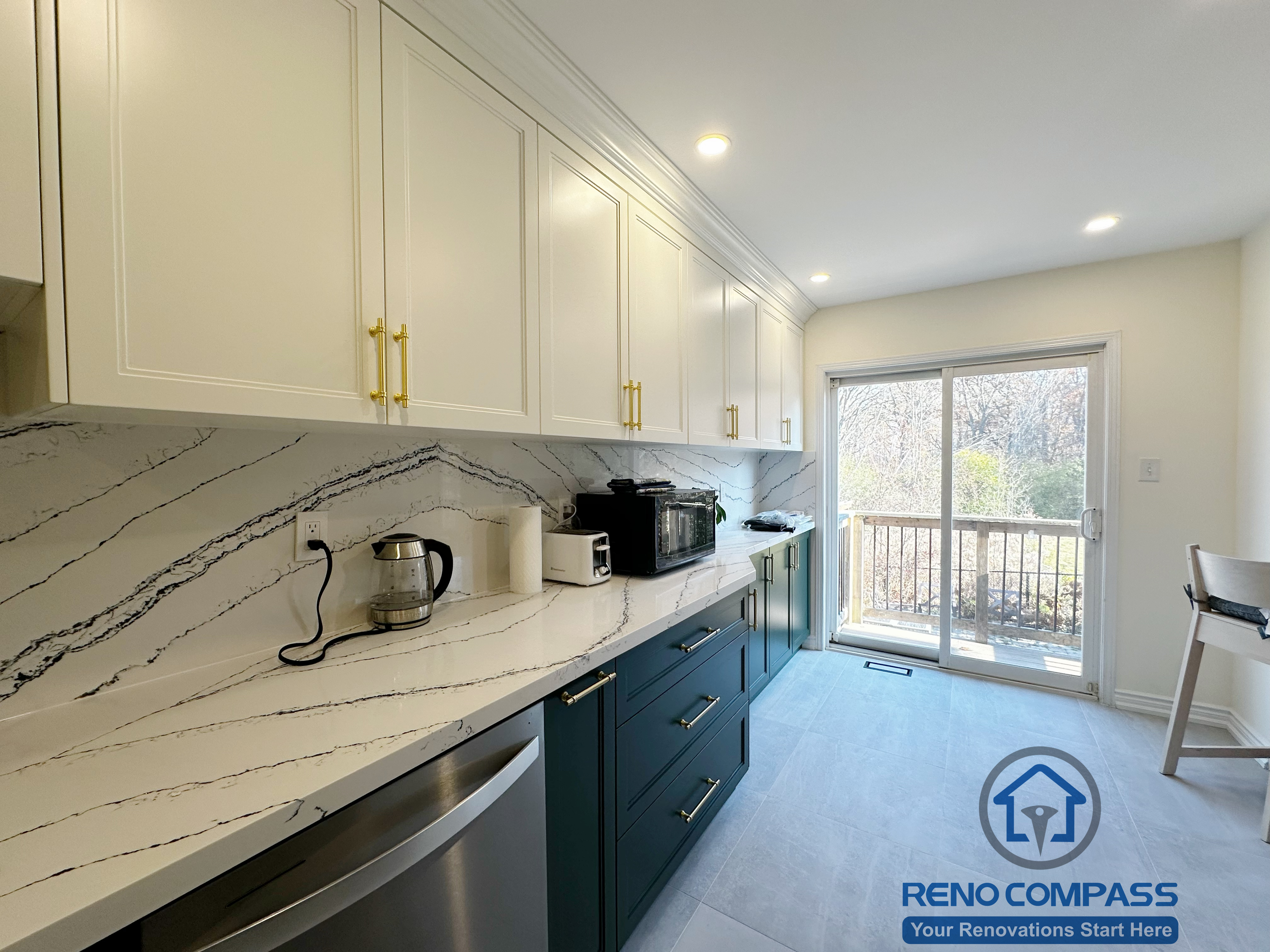 This Mississauga kitchen renovation features an extended preparation counter with quartz surfaces, custom cabinetry, and abundant natural light from the rear patio doors. The layout creates a bright, comfortable workspace that supports daily cooking, food prep, and casual dining connection.