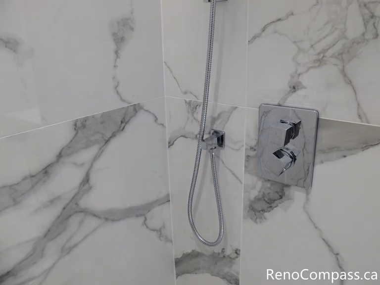 This Richmond Hill bathroom renovation highlights precision installation of a modern shower control valve with marble-look porcelain wall tiles. Completed by a professional Toronto renovation company, the clean tile alignment and high-quality plumbing fixtures create a sleek, durable, and contemporary shower space designed for long-term performance and style.