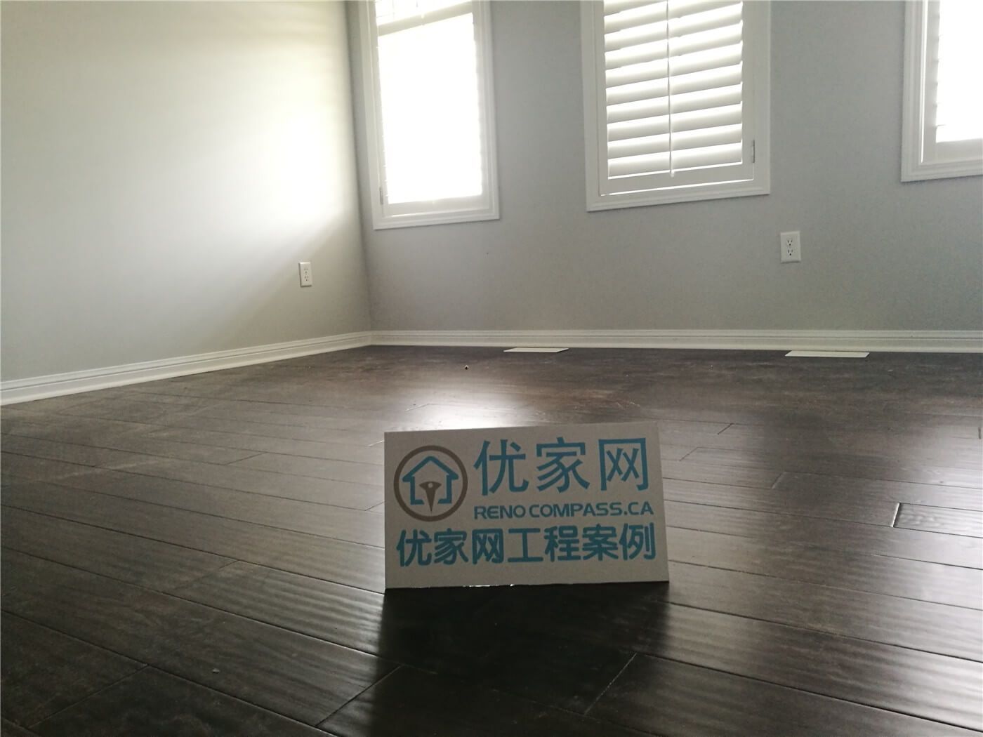 This Scarborough flooring replacement project features newly installed dark hardwood flooring that enhances the room’s depth and modern appeal. The rich wood tone contrasts beautifully with the light grey walls and white baseboards, creating a clean and contemporary atmosphere. Installed by a professional Toronto Renovation Company, the flooring was precisely aligned for a seamless finish and long-term durability.