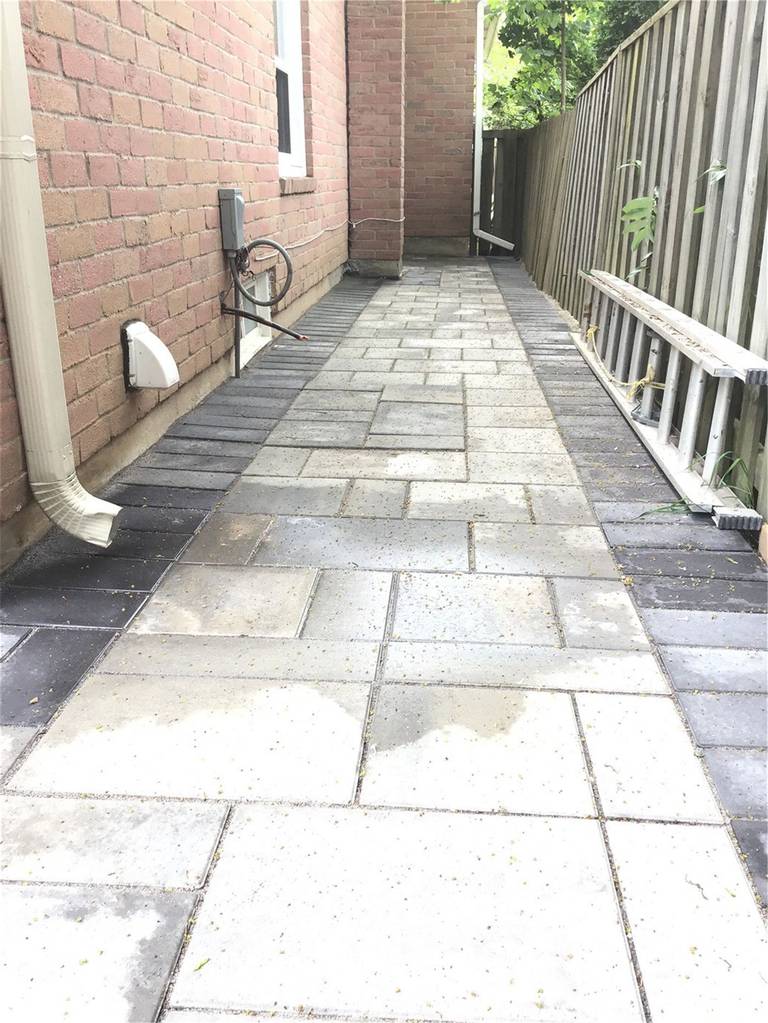 This Oakville interlocking project showcases a clean and functional side walkway built with durable grey pavers and a contrasting dark border design. Installed along the side of the home, the pathway improves drainage, accessibility, and overall property maintenance. The precise layout and professional finish create a sleek, low-maintenance solution ideal for narrow side yard spaces.