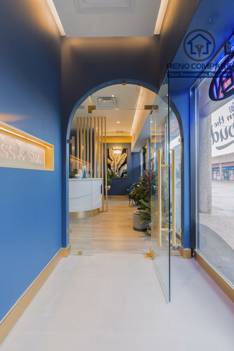 Storefront entrance completed as part of a North York beauty salon renovation. This design features a glass entry door, arched interior transition, branded signage, and clear visual alignment from exterior to reception. The layout creates a strong first impression while guiding clients smoothly into the salon, completed by a professional Toronto renovation company.