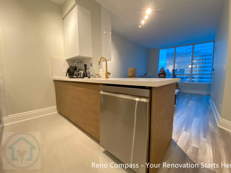 This image showcases a custom kitchen island designed for a North York condo renovation, featuring warm wood-tone cabinetry, an integrated dishwasher, and a quartz countertop with a brass faucet. The island serves as a functional transition between the kitchen and living area, improving workflow while maintaining a clean, modern appearance. Thoughtful lighting and streamlined finishes enhance both daily usability and the overall openness of the condo interior.