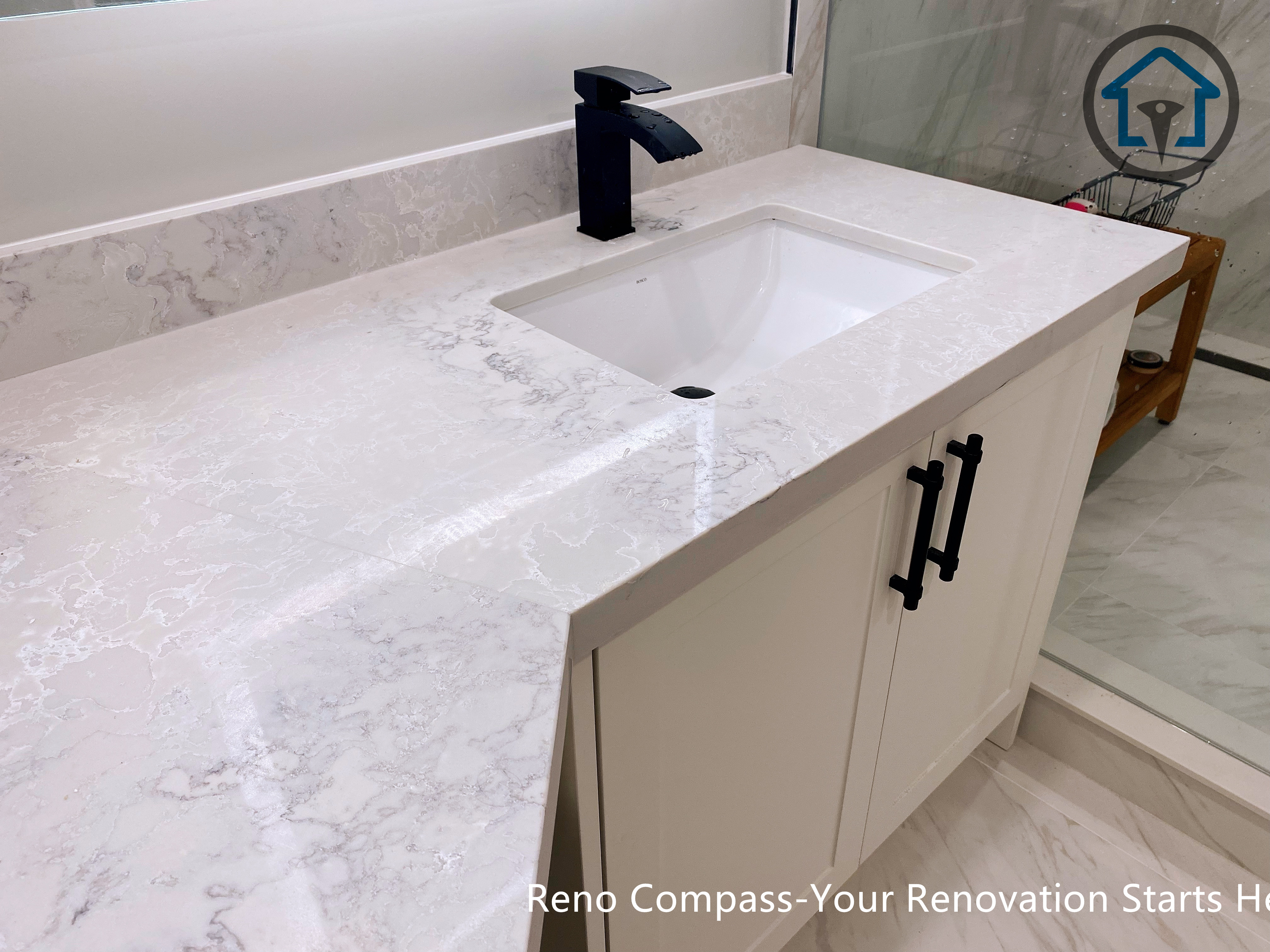 Custom vanity installation in a Newmarket bathroom renovation, featuring a painted MDF vanity, Vicostone quartz countertop, and matte black faucet for a clean, modern finish.