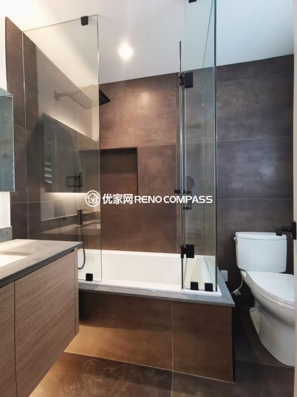Full bathroom renovation completed as part of a North York interior renovation project. This space features a built-in bathtub with a frameless glass enclosure, large-format wall and floor tiles, and a custom wood vanity with stone countertop. The transparent glass panels maintain visual openness while separating wet and dry zones for daily practicality. Clean lines, neutral tones, and integrated lighting create a modern, low-maintenance bathroom designed and built by a Toronto renovation company with attention to detail and long-term usability.