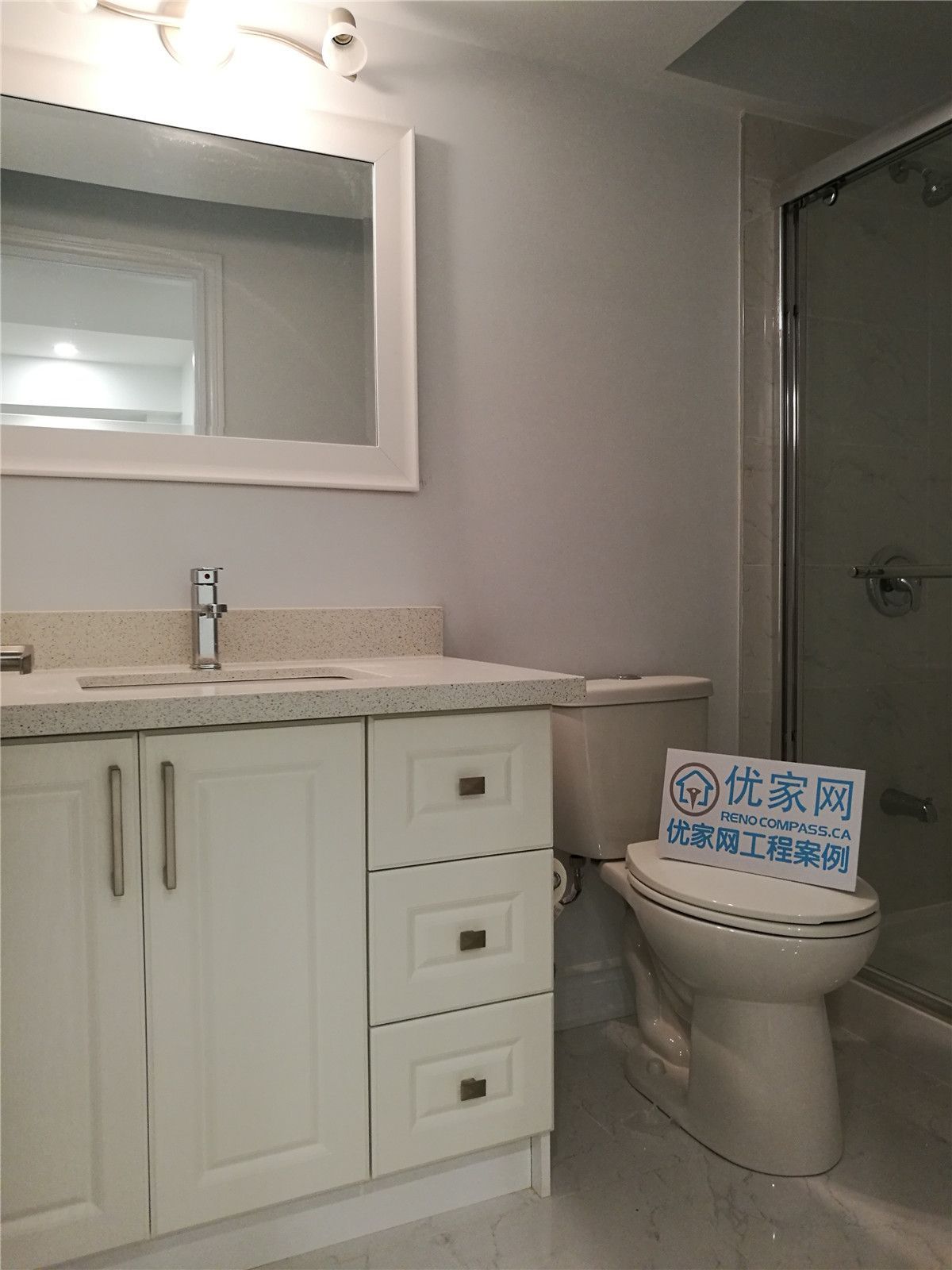 This completed basement bathroom is part of a comprehensive Vaughan basement renovation designed to enhance comfort and everyday functionality. The space features a contemporary vanity with quartz countertop, integrated sink, and ample drawer storage, complemented by a large framed mirror and modern light fixture for a bright and refined atmosphere.

A glass-enclosed shower adds a sleek, streamlined look while maximizing visual space within the basement layout. Neutral tones and coordinated finishes create a clean and cohesive aesthetic throughout the room. Completed by a reliable Toronto Renovation Company, this bathroom upgrade combines practical design, quality materials, and detailed workmanship to deliver lasting value and elevated living standards.