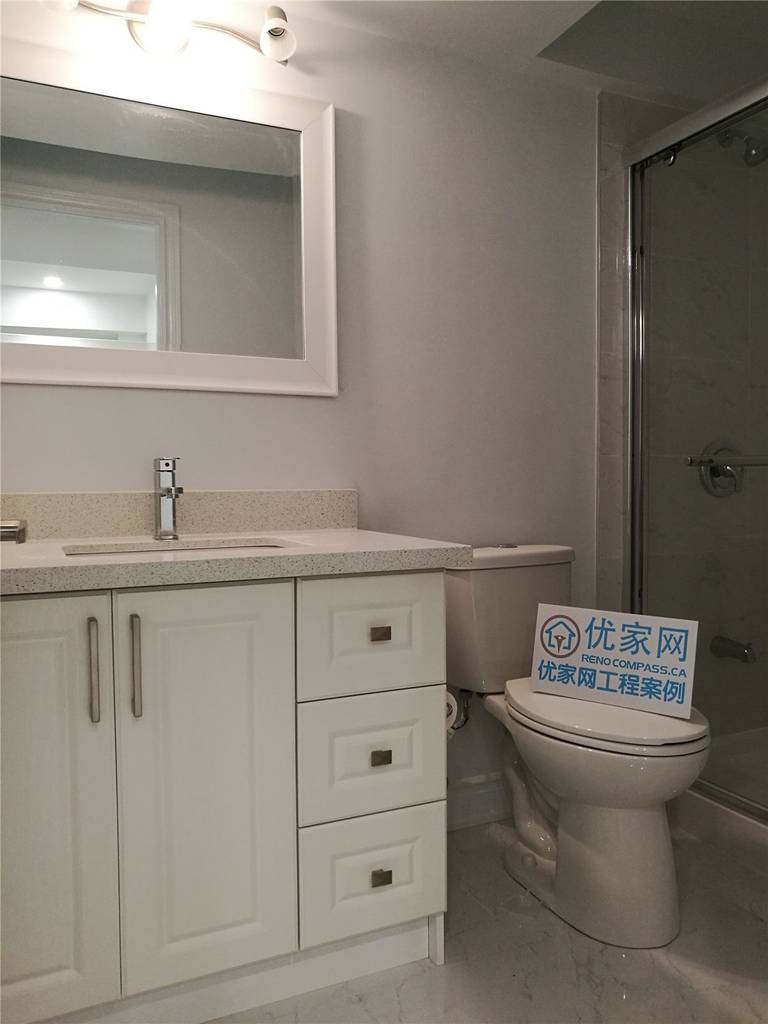 This completed basement bathroom is part of a comprehensive Vaughan basement renovation designed to enhance comfort and everyday functionality. The space features a contemporary vanity with quartz countertop, integrated sink, and ample drawer storage, complemented by a large framed mirror and modern light fixture for a bright and refined atmosphere.

A glass-enclosed shower adds a sleek, streamlined look while maximizing visual space within the basement layout. Neutral tones and coordinated finishes create a clean and cohesive aesthetic throughout the room. Completed by a reliable Toronto Renovation Company, this bathroom upgrade combines practical design, quality materials, and detailed workmanship to deliver lasting value and elevated living standards.