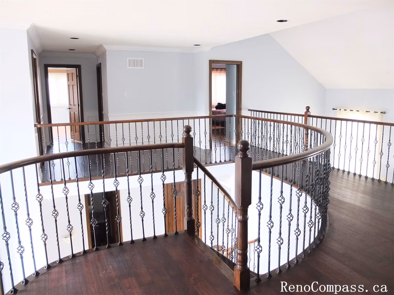This Richmond Hill interior renovation features an upgraded second-floor hallway and open staircase area with custom wood flooring and decorative iron railings. The curved balcony design enhances the home’s architectural flow while providing a bright and spacious upper-level living environment. Modern finishes, clean wall detailing, and improved lighting create a refined and cohesive interior style throughout the home. Completed by a professional Toronto renovation company, this upper-level renovation adds both visual elegance and functional value to the property.