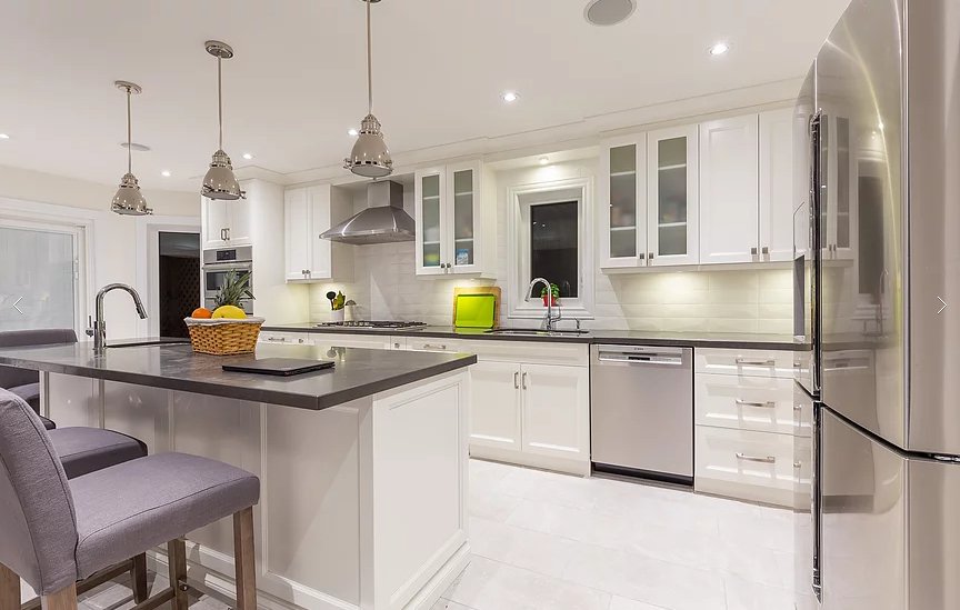 This stunning kitchen from our Vaughan full house renovation features white shaker cabinetry, quartz countertops, stainless steel appliances, and a large central island with pendant lighting. Designed for everyday comfort and entertaining, it blends elegance with high-end craftsmanship.