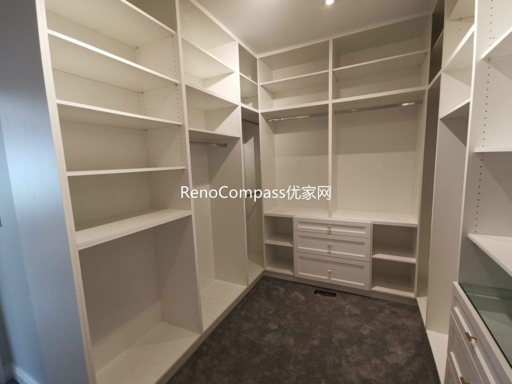 This Richmond Hill walk-in closet renovation features custom built-in shelving, hanging sections, and integrated drawer storage designed for maximum organization and functionality. The clean layout and tailored cabinetry create a spacious and efficient dressing area, showcasing the craftsmanship of a trusted Toronto renovation company specializing in complete home interior renovations.