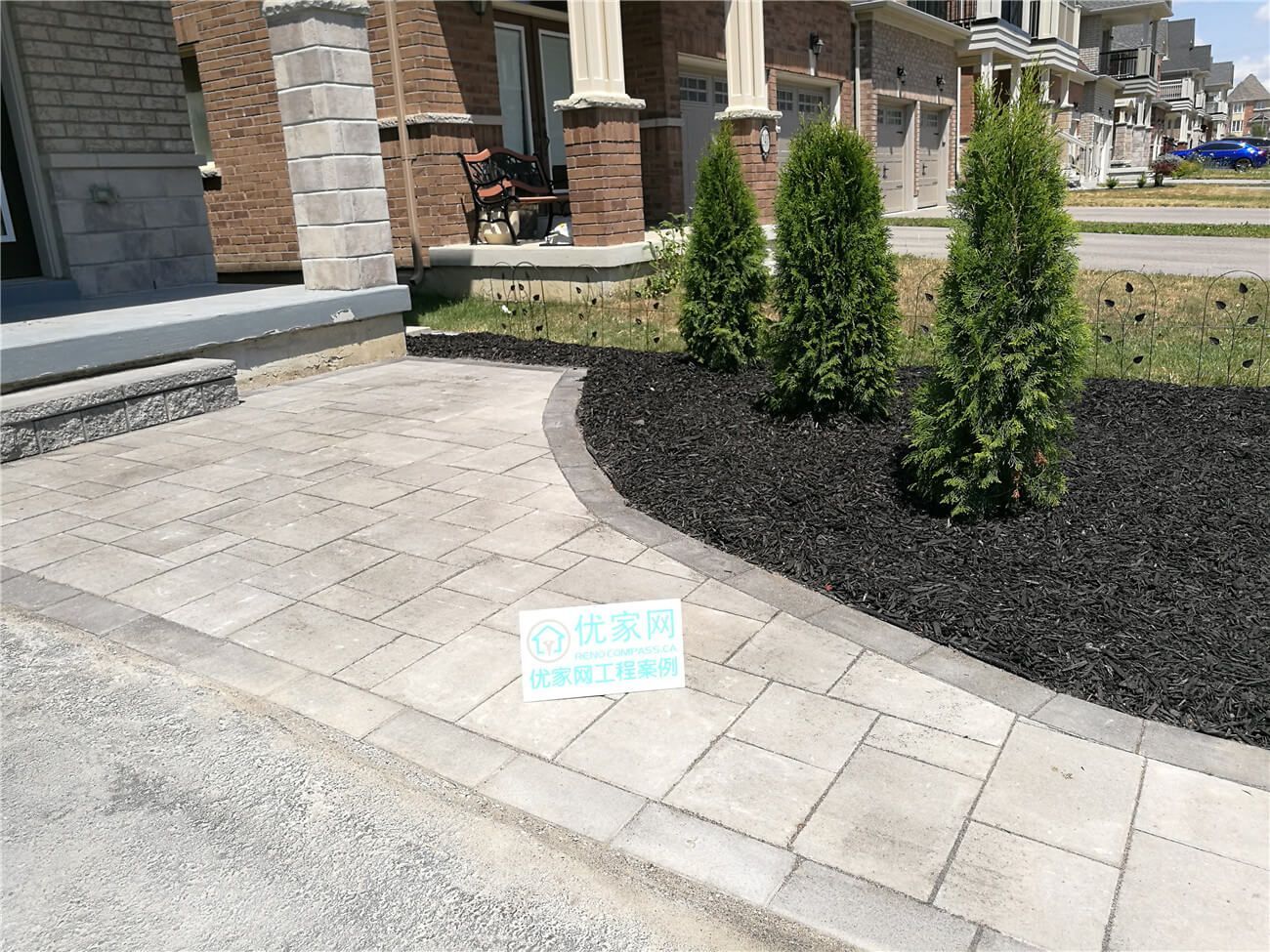 This Stouffville landscaping renovation features a newly installed interlock walkway and refreshed front yard garden bed with evergreen planting and decorative mulch. The curved hardscape design creates a smooth transition from driveway to porch while improving curb appeal and outdoor usability. Completed as part of a professional Toronto landscaping renovation project, the upgrade enhances both the visual balance and long-term durability of this modern residential front entrance.