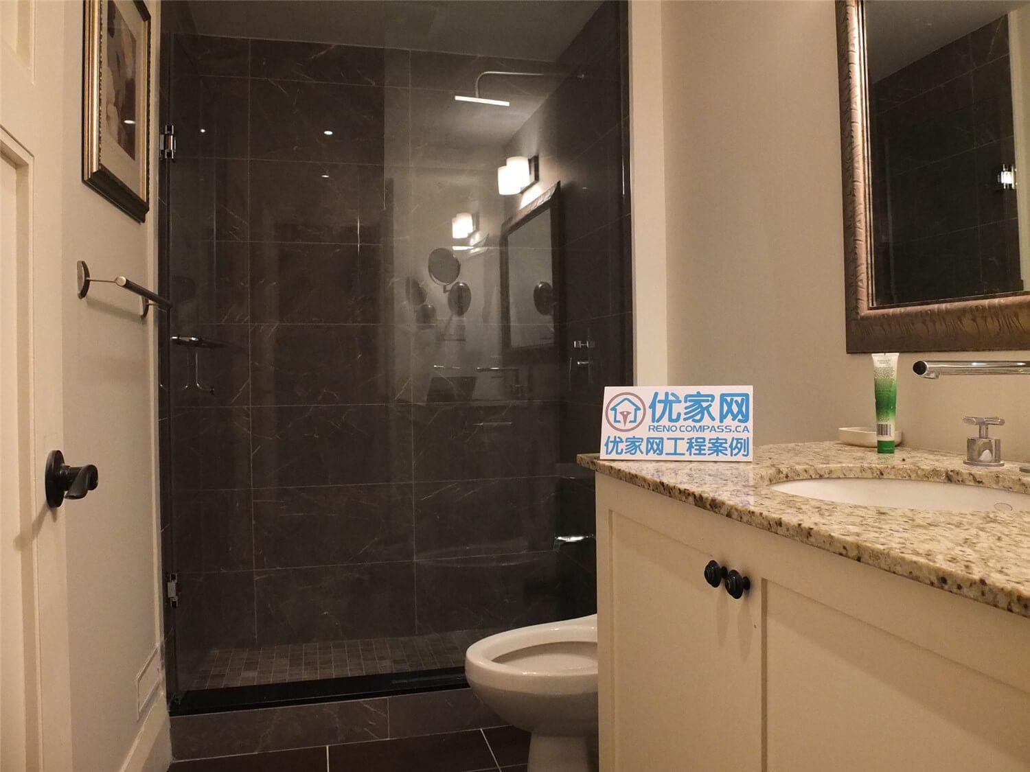 This Oakville basement bathroom renovation features a modern glass shower enclosure with dark tile walls, a granite vanity countertop, and clean white cabinetry. The design combines elegant materials with practical functionality, creating a stylish and comfortable bathroom space. Completed by a professional Toronto Renovation Company, the project highlights precise tile installation, contemporary fixtures, and refined finishing details suitable for modern homes in Oakville and the Greater Toronto Area.