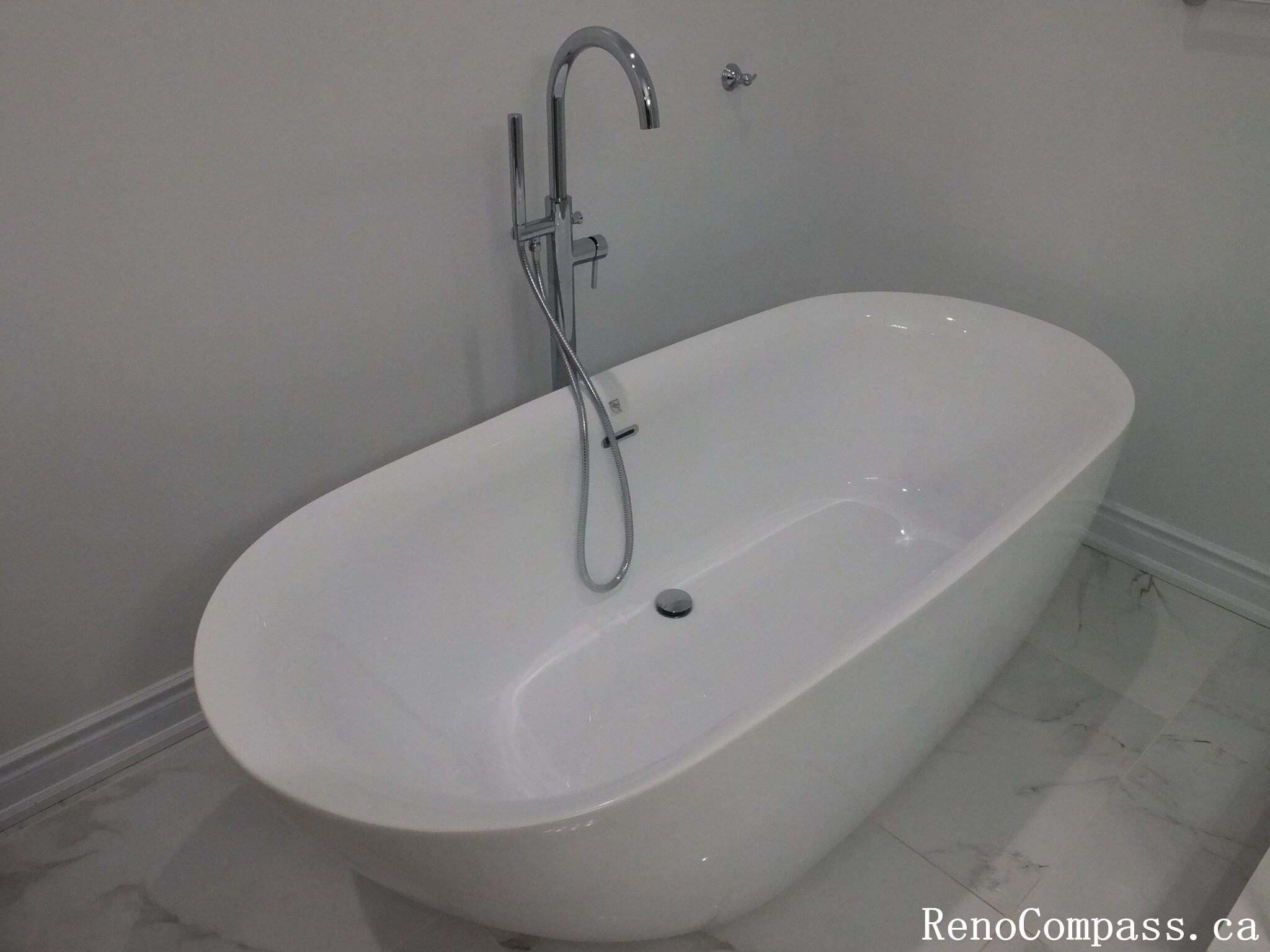 This Richmond Hill bathroom renovation features a sleek freestanding soaking tub paired with modern chrome fixtures and marble-look flooring. Completed by a trusted Toronto renovation company, the design creates a spa-inspired atmosphere focused on relaxation, elegance, and everyday comfort. Clean lines and neutral finishes enhance the sense of space while delivering a timeless and luxurious bathing experience.
