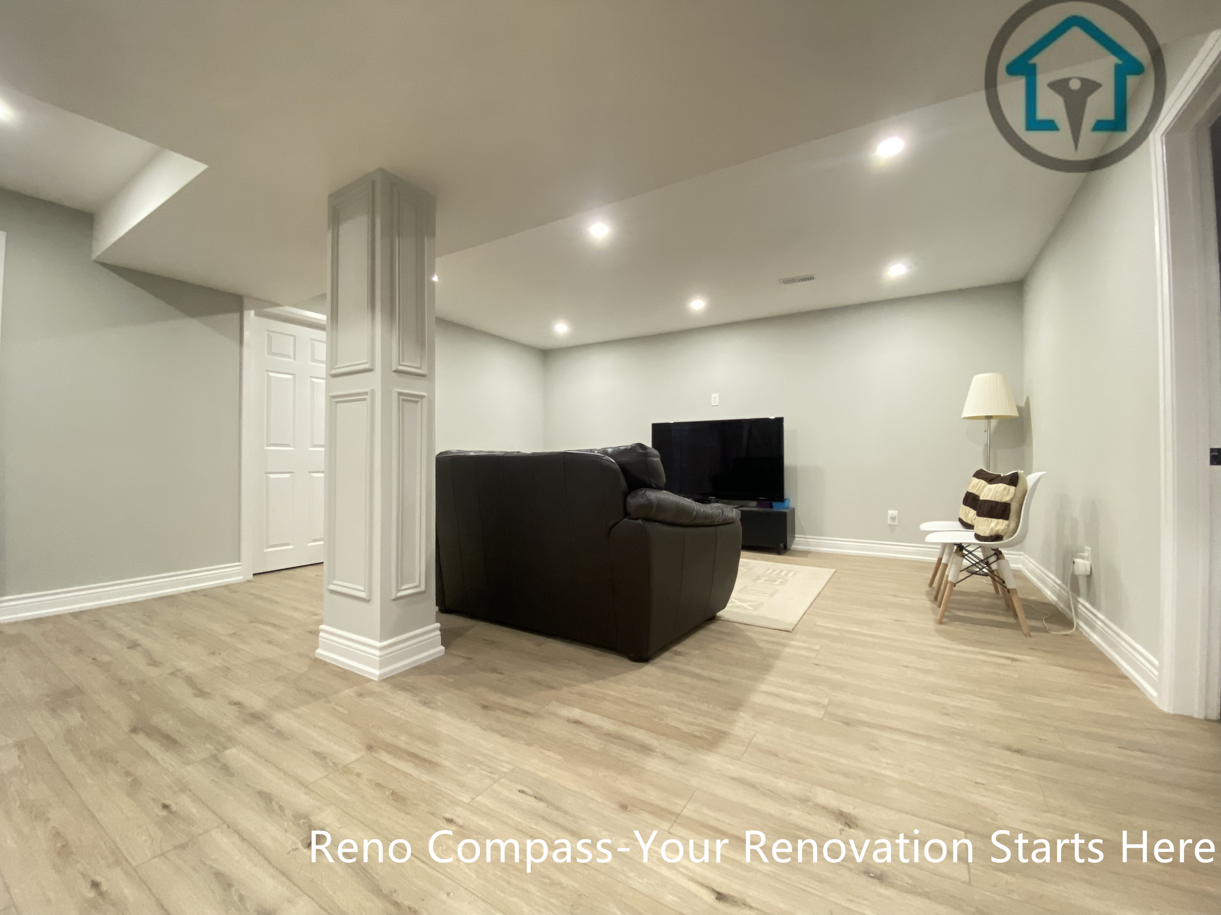 A finished basement living area in Stouffville designed with an open layout, integrated structural columns, recessed ceiling lighting, and durable wood-look flooring.