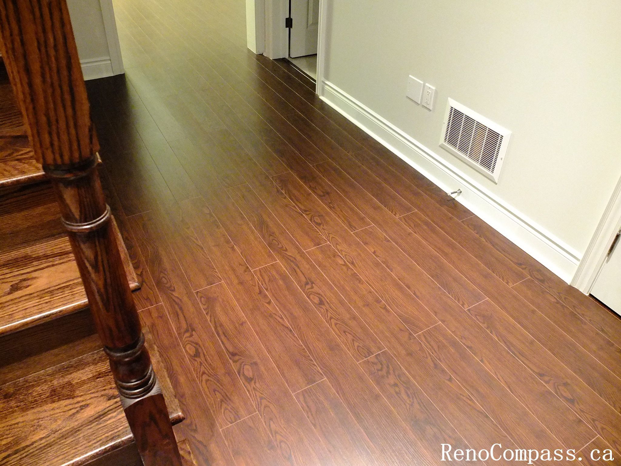Beautiful dark hardwood flooring installation in a renovated Richmond Hill home. Modern interior design with smooth floor finish and elegant staircase craftsmanship. Completed by RenoCompass.ca for a high-quality residential remodel.
