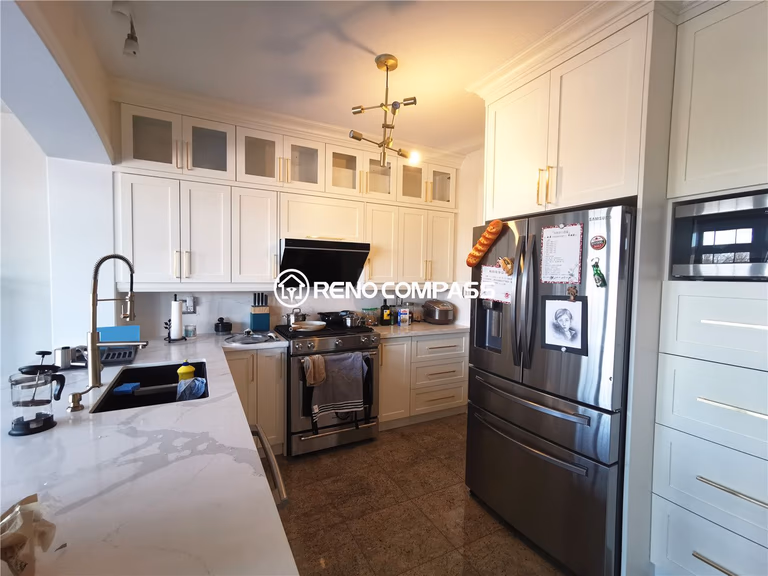 This King City kitchen renovation features custom-built white cabinetry, elegant quartz countertops, and a functional modern layout designed for everyday family living. The space was upgraded with full-height cabinets for maximum storage, a contemporary lighting fixture, and high-end stainless steel appliances to create a bright, refined, and highly practical kitchen environment. Designed and built by Reno Compass Inc., this kitchen transformation blends timeless design with modern functionality for a comfortable and stylish home upgrade.