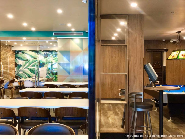 This Barrie commercial renovation highlights a modern bubble tea shop layout featuring open seating areas, custom finishes, and integrated entertainment space. The combination of dining tables, feature walls, and durable commercial flooring creates a welcoming and functional environment for customers. Completed by Reno Compass Inc., a trusted Toronto renovation company, this project showcases professional commercial construction for cafés, dessert shops, and retail spaces across Barrie and surrounding areas.