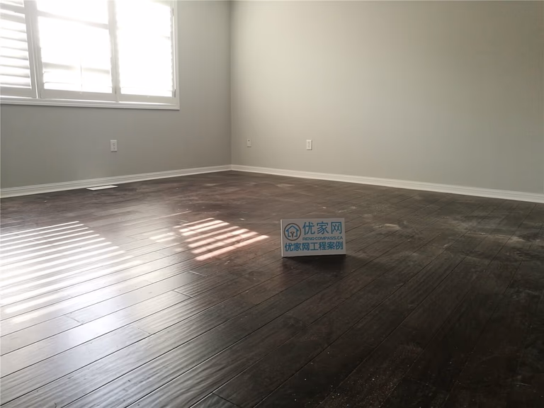 This Scarborough flooring replacement project features newly installed dark hardwood flooring that enhances the room’s depth and modern appeal. The rich wood tone contrasts beautifully with the light grey walls and white baseboards, creating a clean and contemporary atmosphere. Installed by a professional Toronto Renovation Company, the flooring was precisely aligned for a seamless finish and long-term durability.