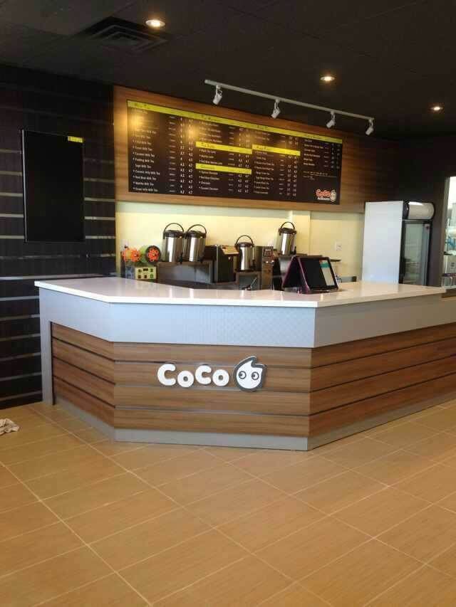 Modern bubble tea shop interior renovation in Toronto featuring a custom service counter, wood panel front design, menu display wall, and functional beverage preparation area. This commercial renovation project creates a clean, welcoming retail space optimized for customer service and efficient drink production. Perfect example of a Toronto bubble tea store renovation and commercial interior upgrade by a professional Toronto renovation company.