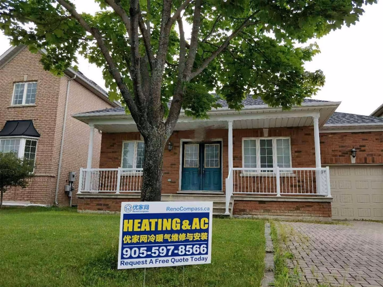 Professional outdoor air conditioner condenser installation by Reno Compass in Toronto. This energy-efficient HVAC unit is securely mounted on a raised stand with proper drainage and ventilation clearance, ensuring optimal cooling performance, durability, and safe operation for residential homes. Installed by licensed technicians for long-term reliability and comfort.