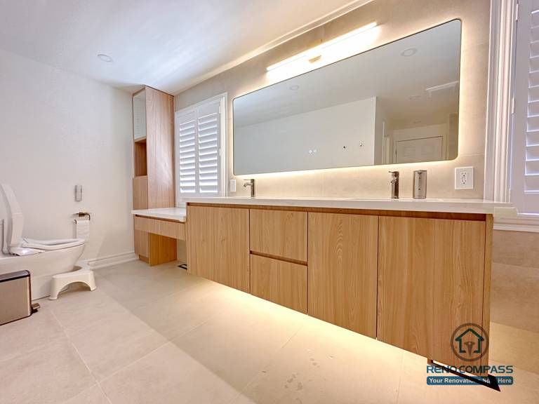 This Markham accessible bathroom renovation features a custom wood-tone vanity with ample floor clearance, integrated lighting, and easy reach access, paired with a thoughtfully positioned toilet area to support safe and comfortable movement. Wide-format tile flooring and unobstructed circulation improve accessibility without compromising design quality. Designed and built by a professional Toronto renovation company, Reno Compass Inc., the space prioritizes safety, usability, and long-term comfort.
