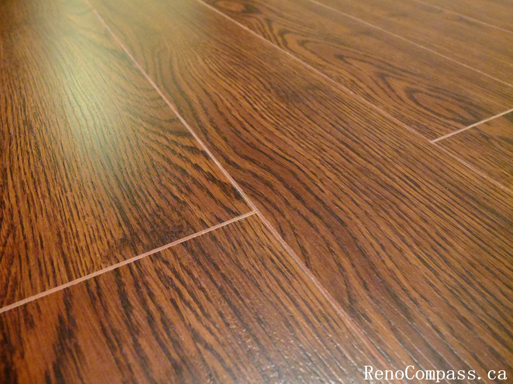 Beautiful dark hardwood flooring installation in a renovated Richmond Hill home. Modern interior design with smooth floor finish and elegant staircase craftsmanship. Completed by RenoCompass.ca for a high-quality residential remodel.