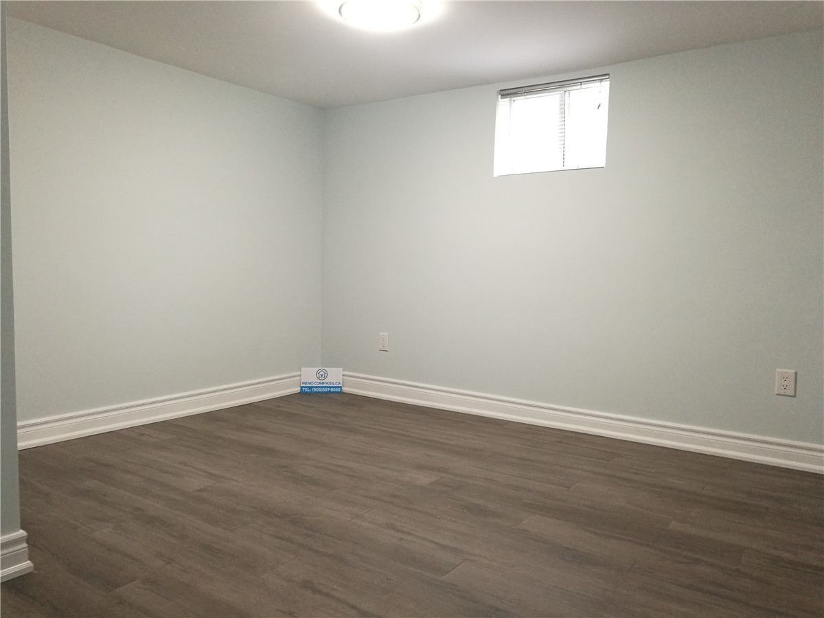 Custom walk-in closet from a Pickering interior renovation project, featuring built-in shelving, hanging rails, new flooring, and clean white finishes. This functional storage upgrade improves organization and everyday use, completed by a professional Toronto renovation company.