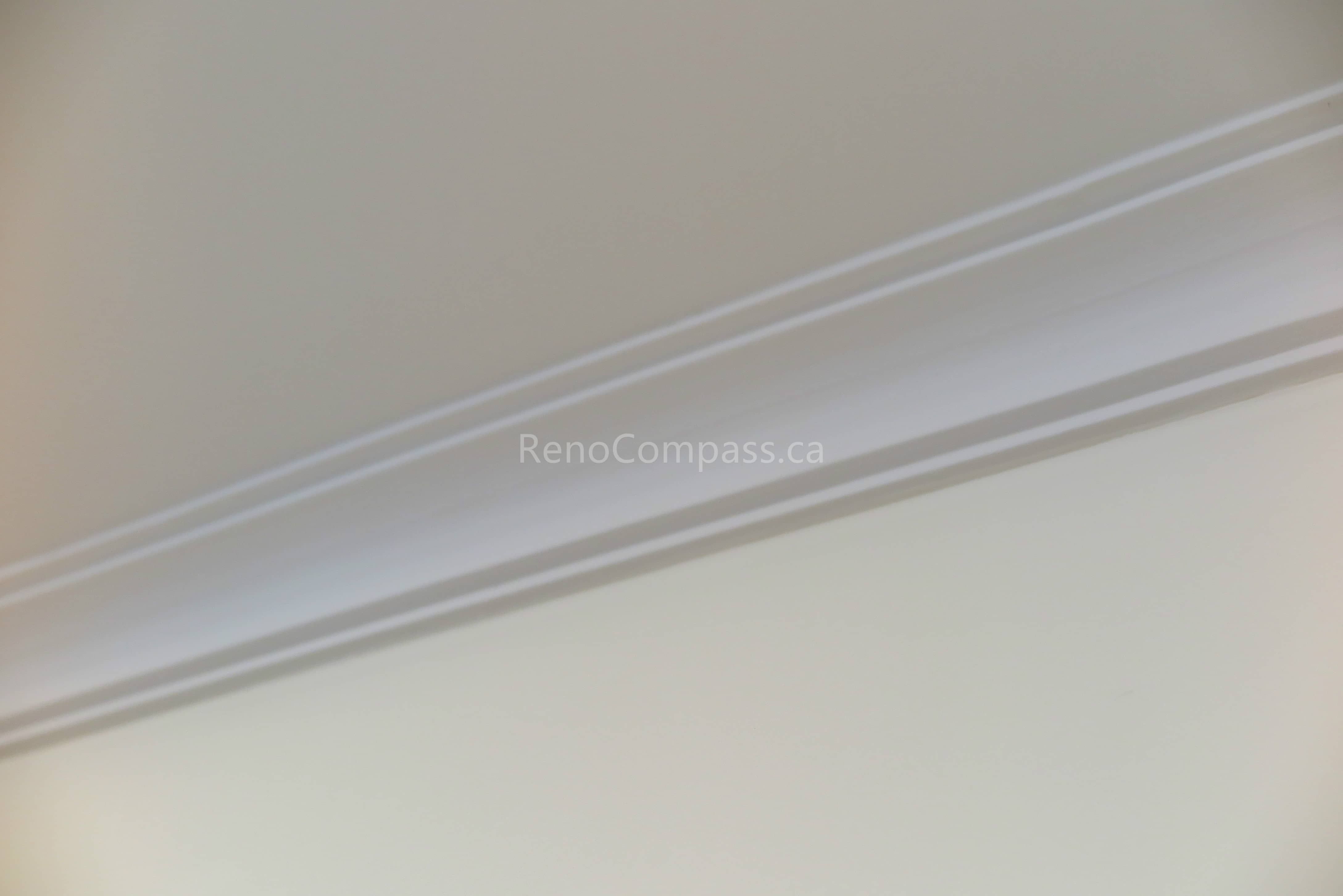 This image features a clean interior trim and crown molding detail completed as part of a North York flooring renovation project. The smooth lines and precise installation create a polished transition between walls and ceilings, enhancing the overall finish of the space. As a reliable Toronto Renovation Company, Reno Compass Inc. pays close attention to finishing details, ensuring flooring, trim, and interior elements work together seamlessly for a refined residential result.