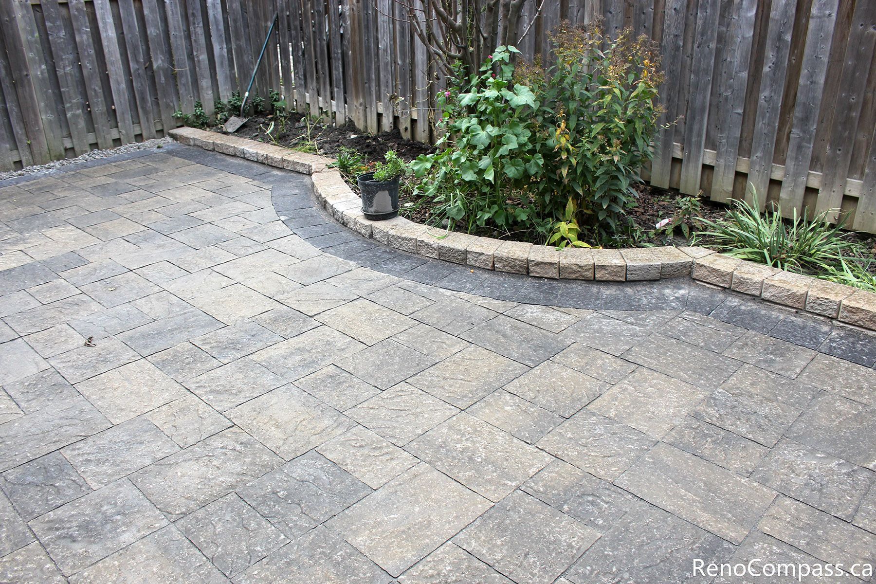 This Markham interlocking patio showcases a clean, modern garden paving layout with precise stone alignment and defined border edging. The interlocking stone surface provides durability, proper drainage, and a polished outdoor finish, seamlessly integrating with the surrounding fence and greenery. Completed by a Toronto renovation company, this landscaping project enhances both usability and long-term outdoor value.