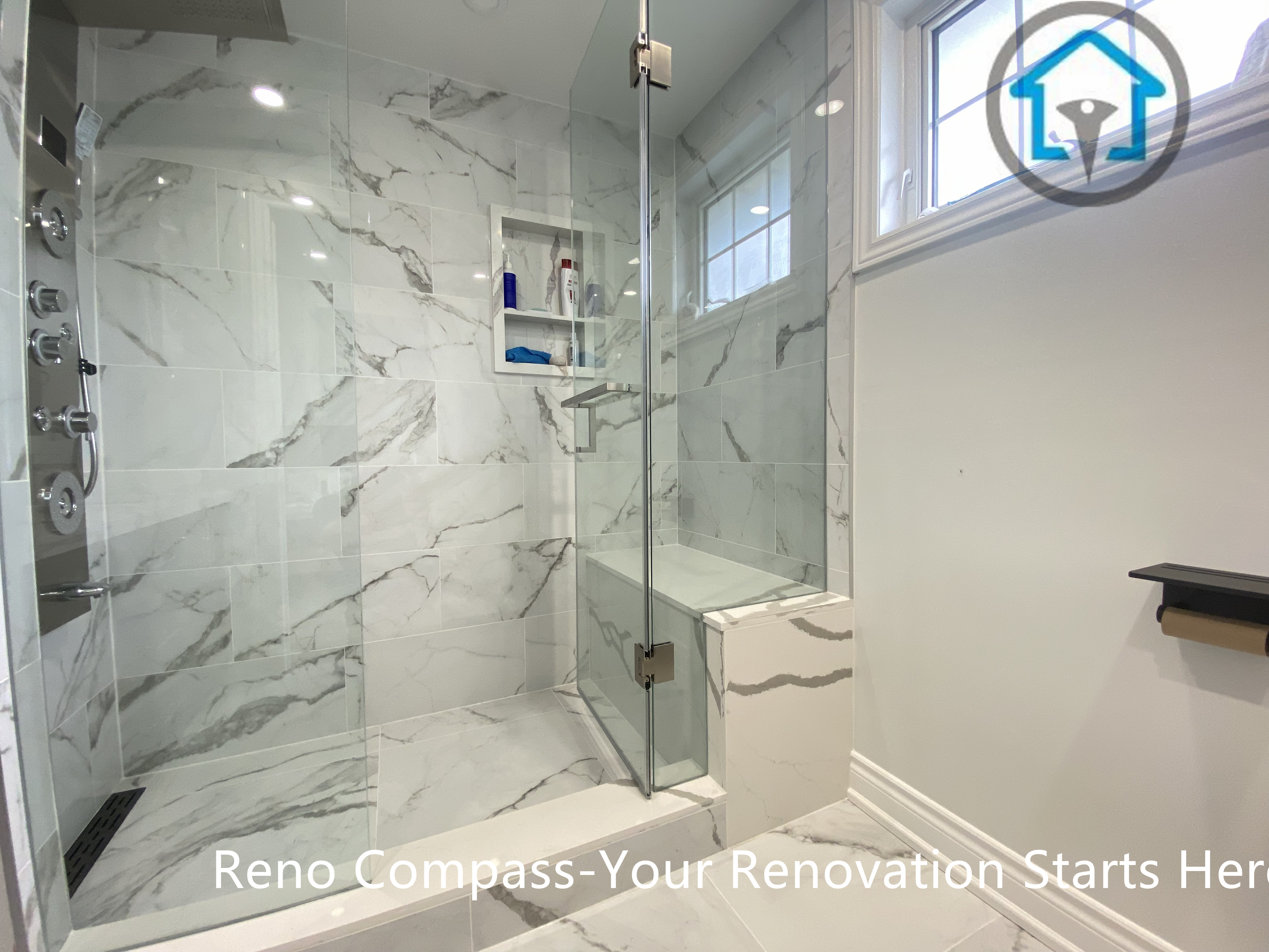 This Stouffville bathroom renovation features a modern walk-in shower finished with large-format marble-look tiles that create a clean, seamless visual flow. A frameless glass enclosure enhances openness while allowing natural light to reflect across the space. Integrated wall niches provide practical storage without interrupting the tile layout, and sleek chrome fixtures add a contemporary touch. The overall design balances functionality and elegance, delivering a bright, spa-inspired bathroom suited for everyday comfort and long-term use.