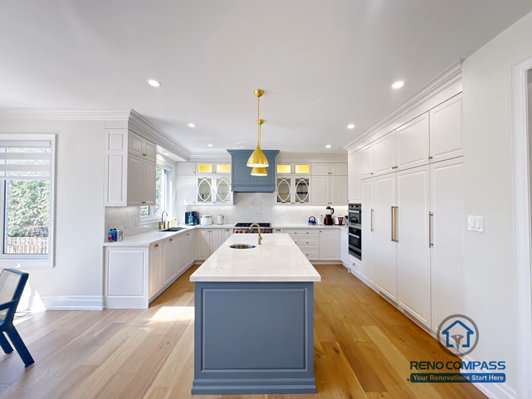 This North York kitchen renovation showcases a symmetrical layout centered around a custom island, with full-height cabinetry, balanced lighting, and clear circulation paths. The design emphasizes proportion, alignment, and everyday usability, creating a calm and organized kitchen environment completed by Reno Compass.