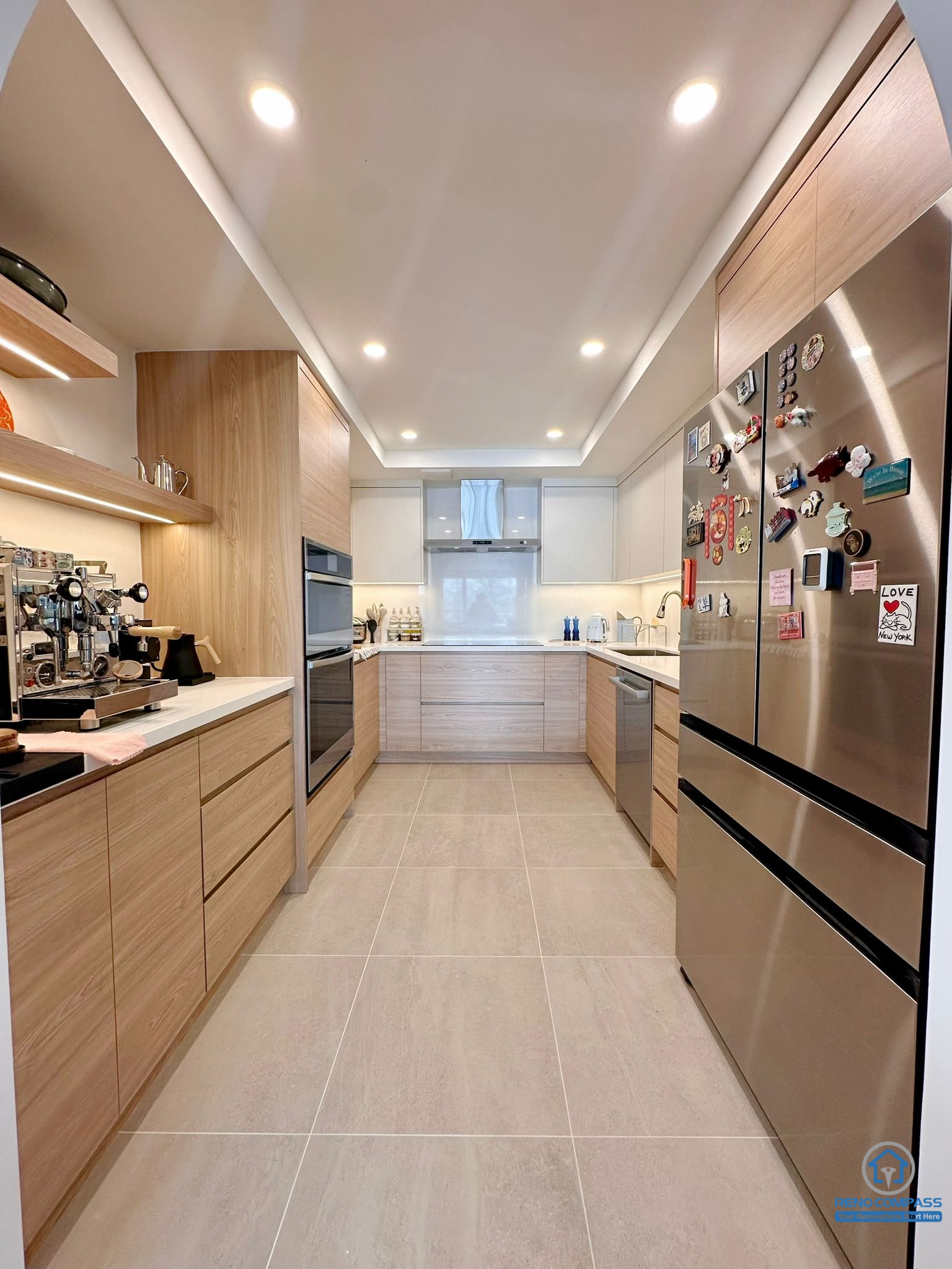A fully renovated modern kitchen in Toronto featuring custom wood cabinetry, integrated appliances, recessed lighting, and a clean contemporary layout. The new design maximizes storage, workflow, and modern aesthetics for everyday living.