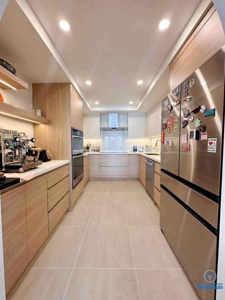 A fully renovated modern kitchen in Toronto featuring custom wood cabinetry, integrated appliances, recessed lighting, and a clean contemporary layout. The new design maximizes storage, workflow, and modern aesthetics for everyday living.
