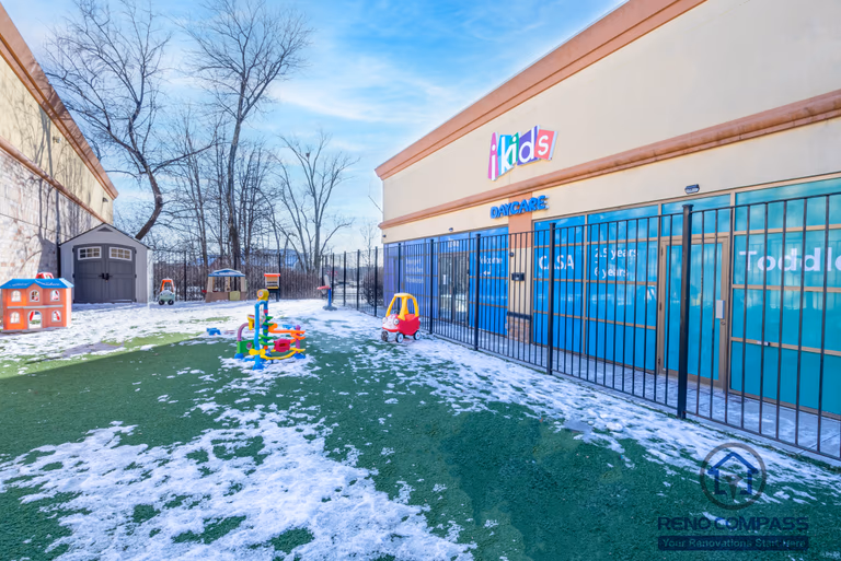 This Markham daycare renovation features a secure and thoughtfully designed outdoor play area that supports active play and daily outdoor activities for young children. The space includes child-safe play equipment installed on durable, low-maintenance turf, allowing year-round usability and easy cleaning. Perimeter fencing and controlled access points enhance safety and supervision, while the open layout encourages movement, exploration, and social interaction. Completed by a Toronto renovation company, Reno Compass Inc., this daycare renovation reflects a strong focus on safety compliance, durability, and functional outdoor design tailored for childcare facilities in Markham.