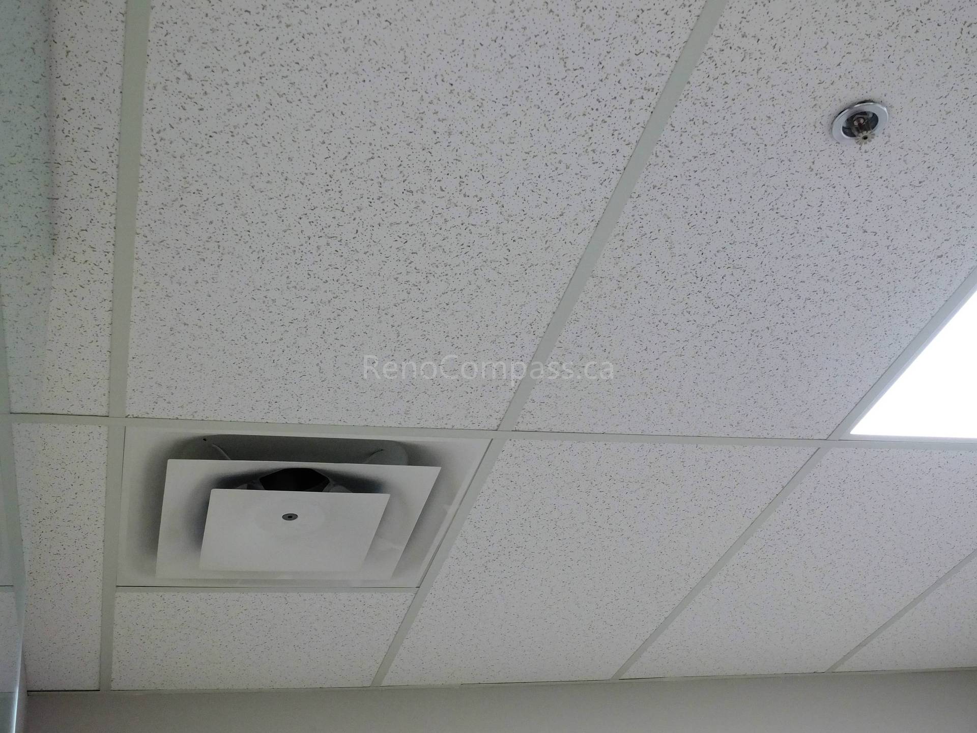 This image shows a close-up of a newly installed ceiling vent integrated into acoustic drop ceiling panels in a North York office renovation project. The modern HVAC setup ensures better air circulation and temperature control, contributing to a comfortable and efficient workspace.