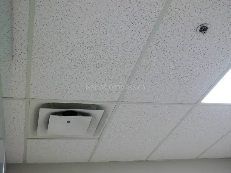 This image shows a close-up of a newly installed ceiling vent integrated into acoustic drop ceiling panels in a North York office renovation project. The modern HVAC setup ensures better air circulation and temperature control, contributing to a comfortable and efficient workspace.