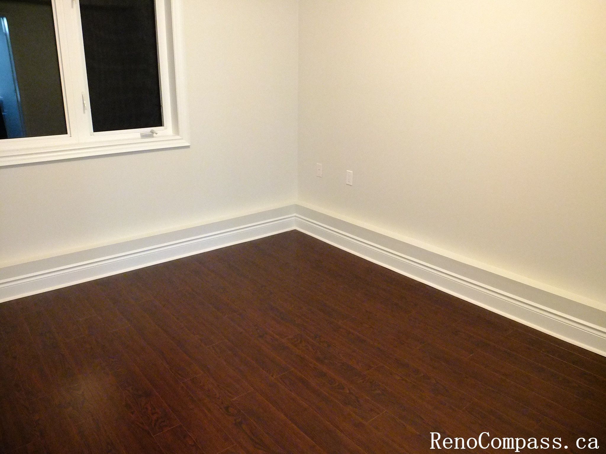 Interior renovation in Richmond Hill showcasing smooth painted walls, new hardwood floor, and clean trim work. A professional home improvement project by RenoCompass.ca bringing warmth and style to living spaces.
