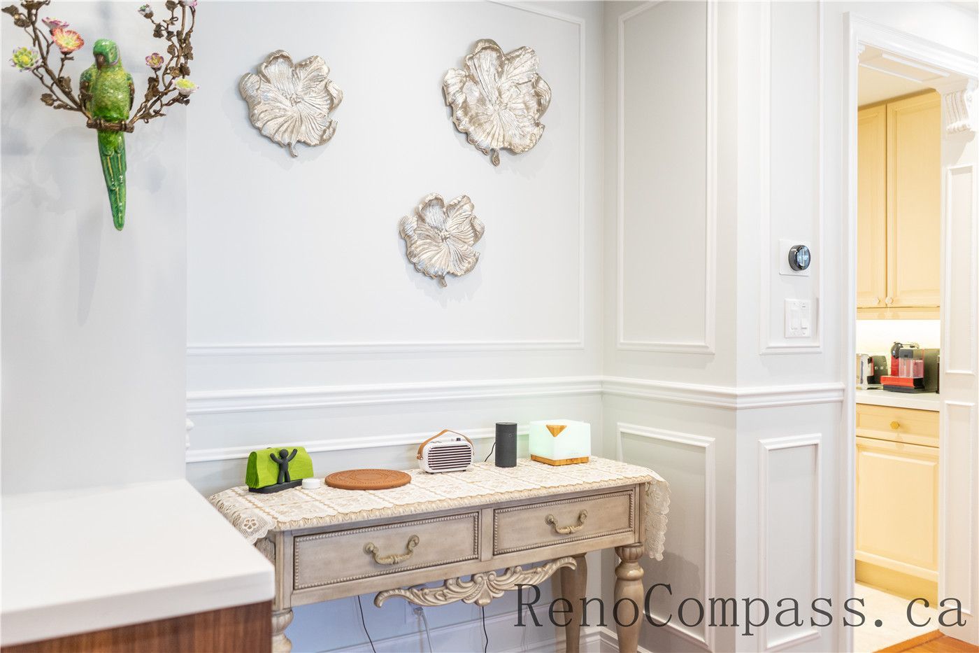 This Richmond Hill interior renovation showcases elegant wall molding details, decorative lighting accents, and a refined transitional space connecting the foyer and kitchen. The upgraded finishes and custom trim work enhance visual continuity throughout the home, reflecting the craftsmanship and design expertise of a professional Toronto renovation company specializing in complete house interior transformations.