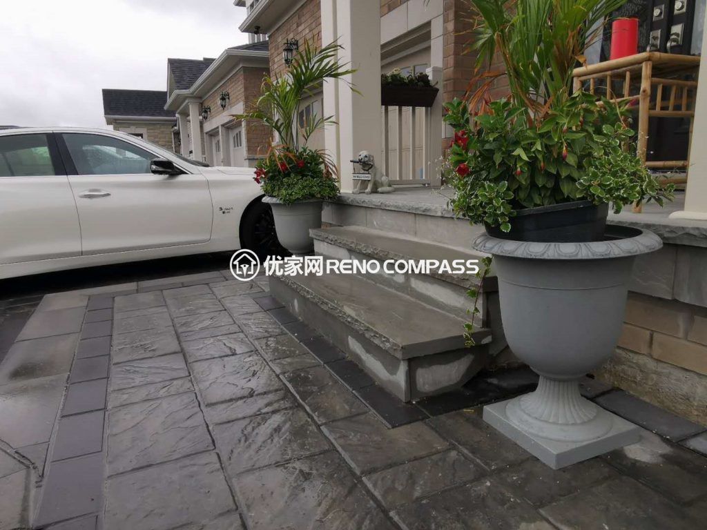 Stylish front entrance in Aurora featuring custom interlocking stone steps and an elegant grey-tone driveway. Reno Compass designed this space to enhance curb appeal with clean lines, premium materials, and professional Toronto-level renovation quality.