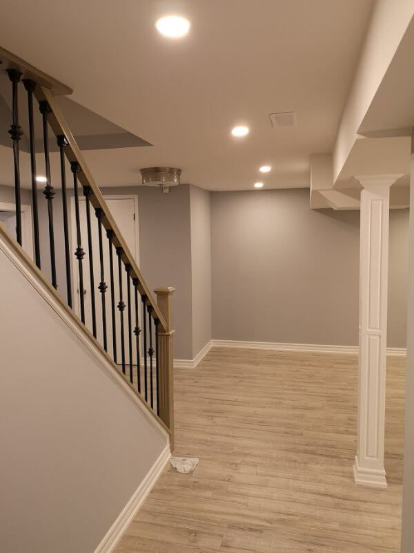 This finished basement renovation in Markham showcases a bright open-concept layout with new flooring, upgraded staircase, modern columns, and recessed lighting. Completed by a trusted Toronto renovation company, the project transforms the basement into a spacious and comfortable living area, enhancing both property value and everyday functionality.