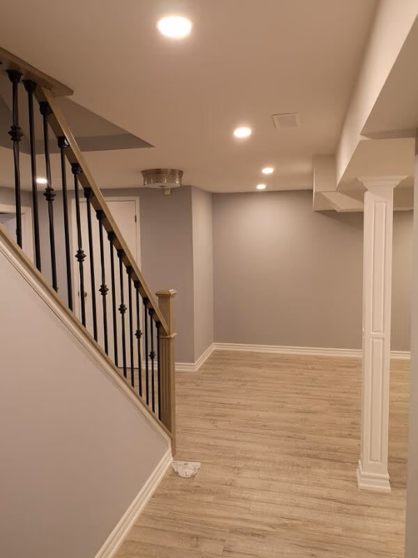 This finished basement renovation in Markham showcases a bright open-concept layout with new flooring, upgraded staircase, modern columns, and recessed lighting. Completed by a trusted Toronto renovation company, the project transforms the basement into a spacious and comfortable living area, enhancing both property value and everyday functionality.