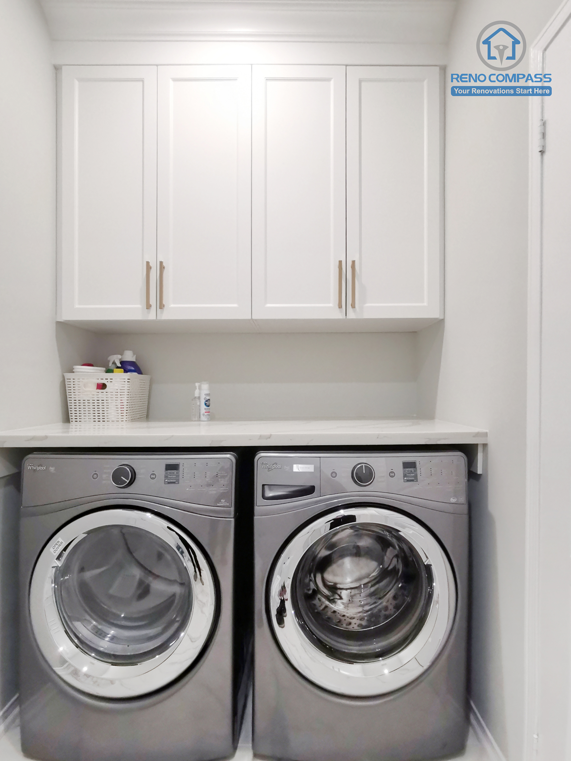 This Markham interior renovation includes a clean and highly functional custom laundry room designed to maximize efficiency within a compact footprint. The space features stacked front-load washer and dryer units integrated beneath custom white shaker cabinetry, providing concealed storage for daily household essentials. A seamless countertop offers a practical folding and sorting surface, while neutral finishes maintain visual continuity with the rest of the home. The streamlined layout improves circulation and ease of use without sacrificing storage capacity. Completed by Reno Compass, this laundry room renovation reflects a thoughtful approach to interior planning, balancing practicality, durability, and a cohesive modern aesthetic suited for Markham residences.