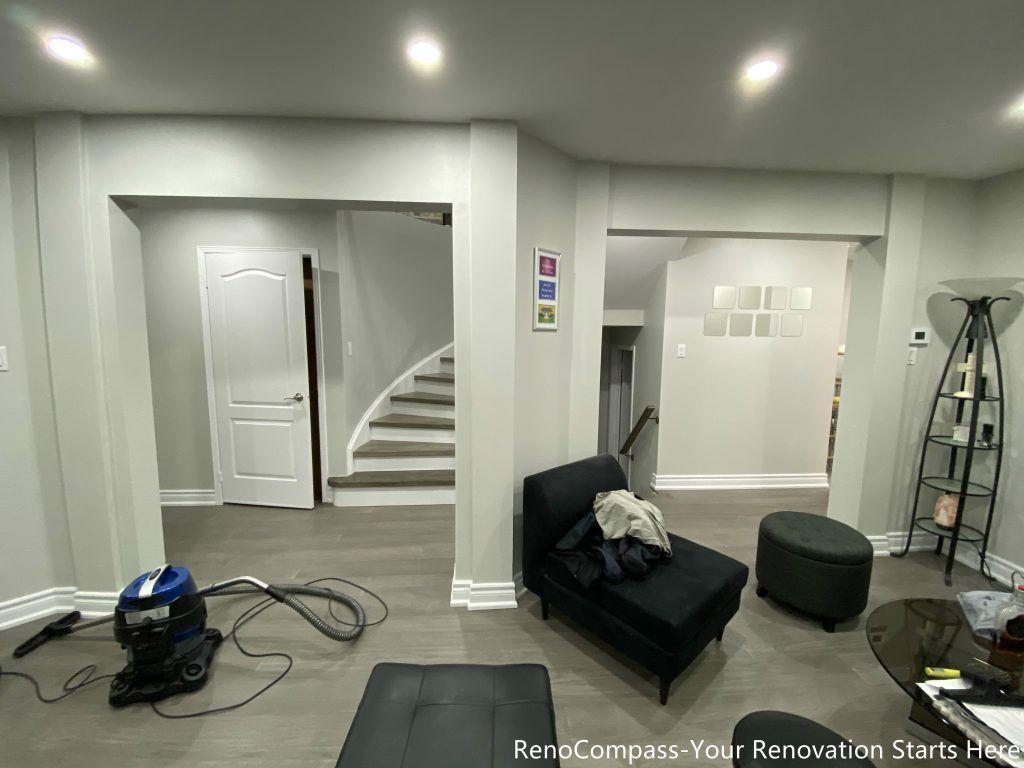 This Mississauga interior renovation features a modern open-concept living space with upgraded flooring, smooth ceilings, and recessed pot lights that create a bright and welcoming atmosphere. The redesigned layout highlights a custom staircase feature wall, contemporary trim work, and a seamless transition between living and dining areas. Completed by a professional Toronto renovation company, this renovation focuses on enhancing space flow, lighting quality, and overall home comfort while adding long-term value and a clean modern aesthetic.
