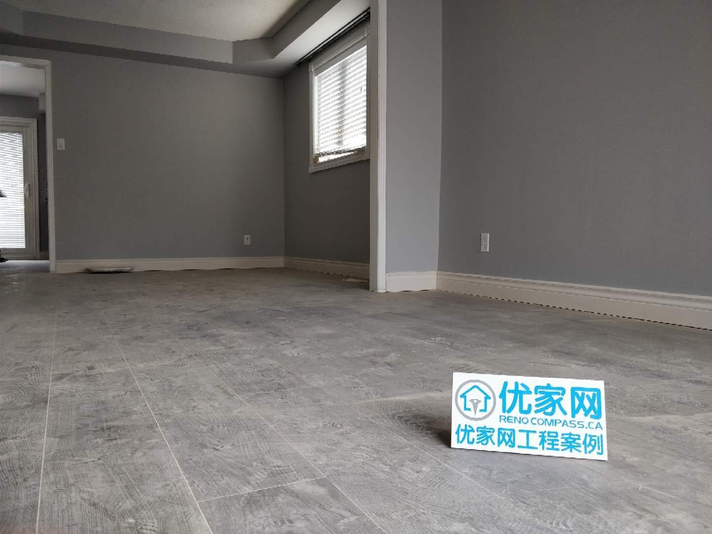 This living area renovation in Ajax features modern grey-tone flooring, clean wall finishes, and a minimalist interior layout. The updated space highlights improved durability and a contemporary aesthetic, creating a bright and open environment. As part of a full house renovation project, the flooring and wall upgrades enhance both comfort and long-term value for the homeowner.