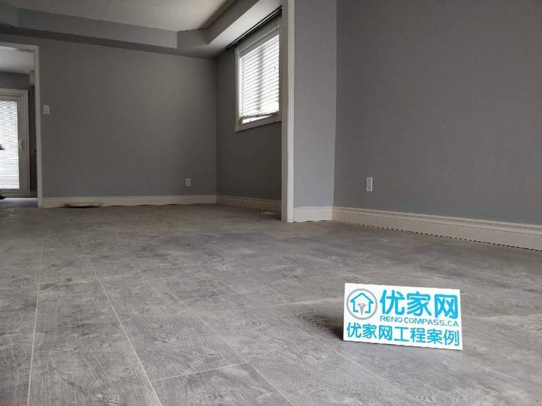 This living area renovation in Ajax features modern grey-tone flooring, clean wall finishes, and a minimalist interior layout. The updated space highlights improved durability and a contemporary aesthetic, creating a bright and open environment. As part of a full house renovation project, the flooring and wall upgrades enhance both comfort and long-term value for the homeowner.