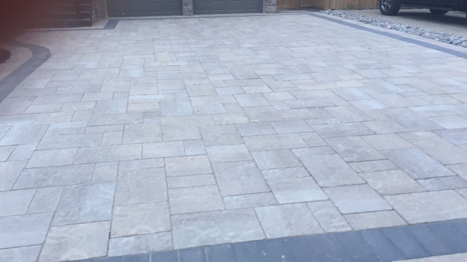 This Toronto interlocking driveway features a clean, modern stone layout with durable pavers and a structured border finish. Professionally installed for long-lasting performance, it enhances curb appeal while providing a smooth, low-maintenance surface ideal for residential landscaping projects.