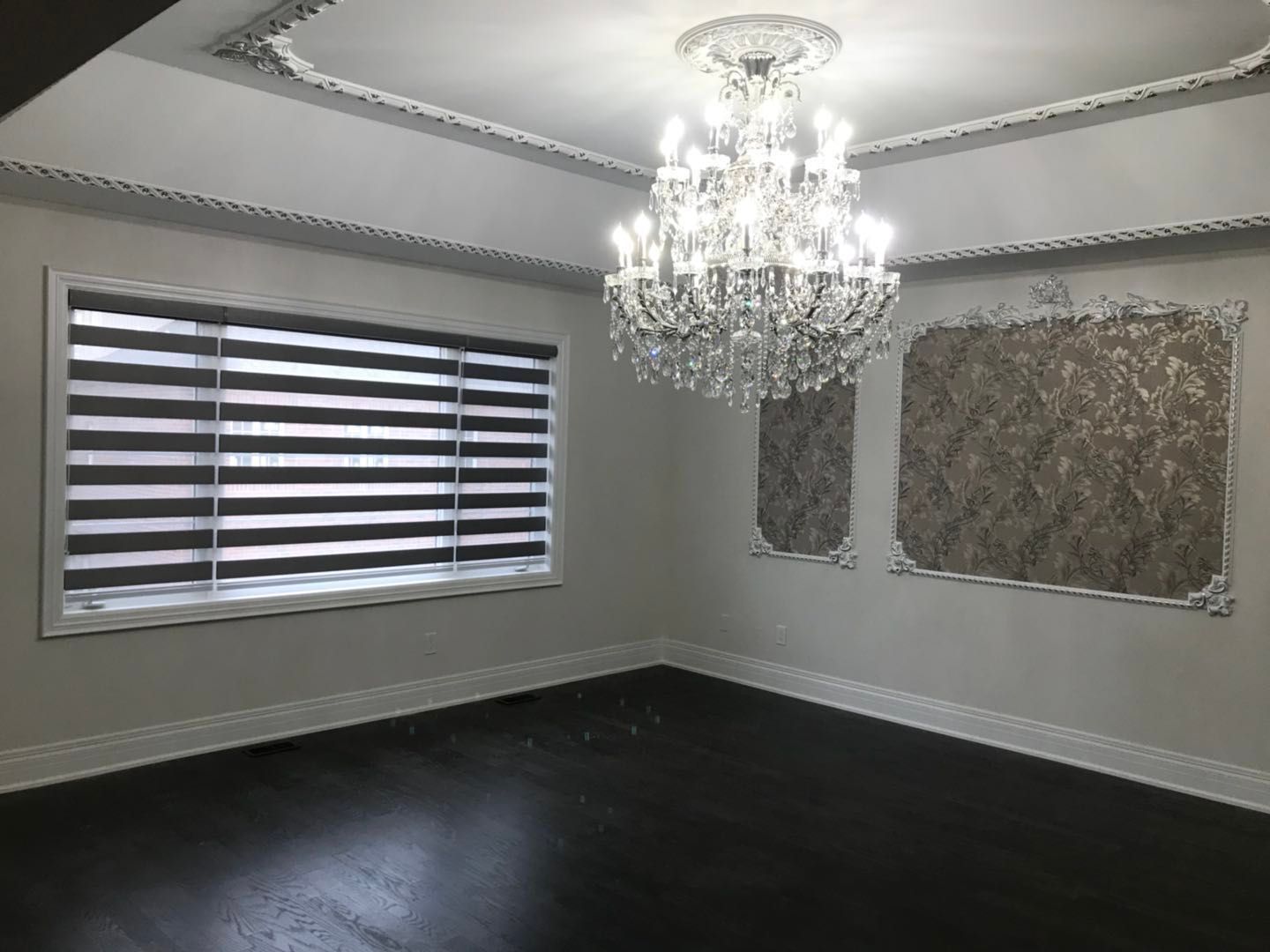 Custom zebra blinds installation in Toronto dining room by professional Toronto renovation company Reno Compass Inc. Featuring dual-layer light filtering shades, clean white window trim, modern chandelier lighting, and elegant wall panel detailing. This window treatment upgrade enhances privacy, natural light control, and interior aesthetics with a sleek and contemporary finish.
