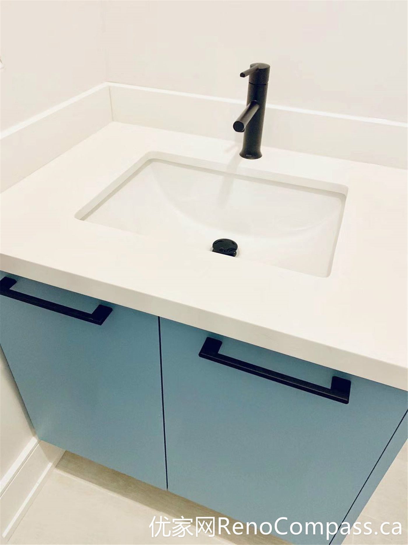 A close-up view of the custom bathroom vanity from this Markham renovation showcases a seamless integrated sink, soft blue cabinetry, and a matte black faucet. The clean lines and durable materials reflect a modern design approach focused on both functionality and long-term performance.